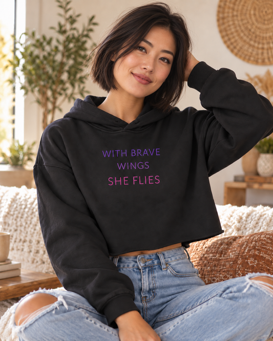 With Brave Wings She Flies crop hoodie in Black modeled by an East Asian woman – lifestyle hero