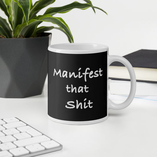 Manifest That Shit white ceramic mug – 11 oz office lifestyle setting